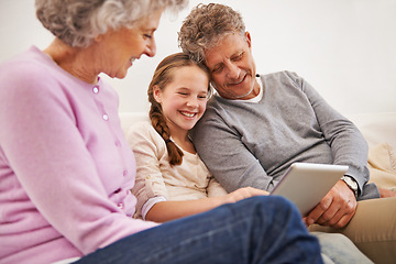 Image showing Tablet, grandma and grandpa with girl in house, senior and woman babysitting granddaughter. Living room, old man and female person with internet for growth and development of child with movies