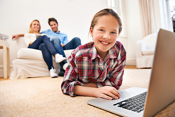Image showing Parents, portrait or girl with laptop for elearning or studying for remote education on carpet at home. Relax, father or mother with family blur, smile or happy child streaming video, film or movies