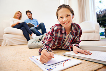 Image showing Portrait, parents or girl writing homework in school notebook for education or assignment on carpet. Smile, floor or female kid in a house for learning, creativity or studying for child development