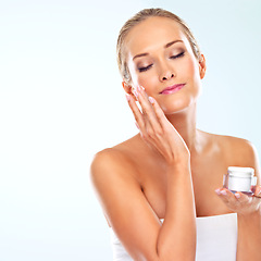 Image showing Mockup, woman and portrait with skincare cream for self care, cosmetics and application in studio. Female person, satisfaction and facial product with beauty, lotion and glow on blue background