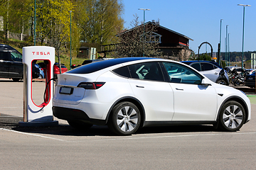 Image showing White Tesla Model Y Electric Car Charging Battery