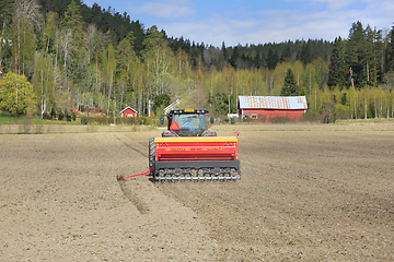 Image showing Tractor and Seed Drill at Work