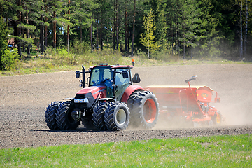 Image showing Case IH Farmall Tractor and Seeder in Field 