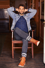 Image showing Smile, happy and portrait of male person on chair, living room or home for relax. Face, confidence and style for handsome man model with hands behind head, fashionable and on holiday in Texas