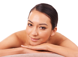 Image showing Health, portrait and woman at spa for massage with skincare, wellness or body treatment in studio. Happy, smile and face of Asian female person on table for relaxing routine by white background.