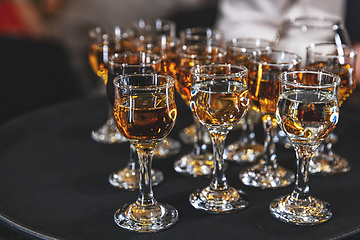 Image showing Crystal glasses filled with amber-colored liquor