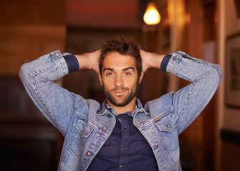 Image showing Portrait, smile and handsome male person in home, fashion and denim for relax or holiday. Confidence, smirk and style for man model with hands behind head, trendy and on vacation in Texas house