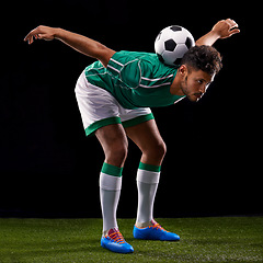 Image showing Man, ball and soccer for balance, sport and match for fitness, game and active for sportswear on grass or field. Arab person, role model or athlete and practice for competitive on dark background