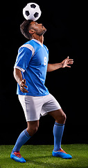 Image showing Man, soccer ball and play for balance, sport and fitness for game and active for sportswear on grass or field. Arab person or athlete and practice for strong and competitive on dark background