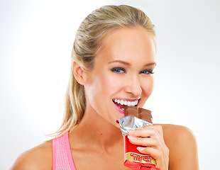 Image showing Portrait, chocolate bar and woman with wellness, candy and unhealthy snack on white studio background. Fitness, person or model with cocoa product or eating a cheat day treat with diet plan and sugar