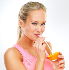 Image showing Woman, portrait and orange fruit with straw in studio for healthy nutrition or vitamin c fiber, drinking or white background. Female person, face and diet wellness self care, lose weight or mockup