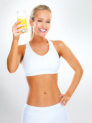 Image showing Studio, citrus drink and portrait of woman with smile for healthy diet, weight loss or nutrition. Underwear, glass and person with orange juice for detox, vitamin c or wellness on white background