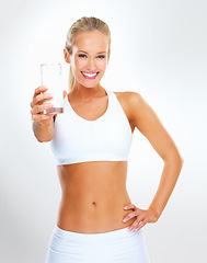 Image showing Portrait, happy woman and glass of milk for exercise in studio background with nutrition, vitamins and calcium. Organic, healthy and wellness for diet with dairy, protein and muscle to support bone