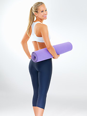 Image showing Woman, portrait and yoga mat with fitness style and happy in a studio with gym gear. Health, outfit and female person with pilates and white background and confidence ready for wellness class