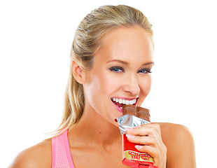 Image showing White background, portrait and bite of chocolate by woman, smile and cheat day on diet for athlete. Adult, female person and girl with happy for dessert to enjoy after exercise or workout in studio