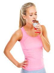 Image showing Fitness, health and studio with woman and chocolate bar for unhealthy food choice to indulge for sweetness. Female person, isolated and white background with mockup, calories and eating candy