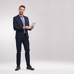 Image showing Businessman, smile and confident with tablet in studio on white background for startup company as salesman. Portrait, entrepreneur and happy to browse internet, website and network with mockup