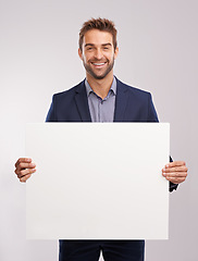 Image showing Businessman, smile and confident with poster in studio on white background for startup company as salesman. Portrait, entrepreneur and happy to advertise for sales and corporate with mockup