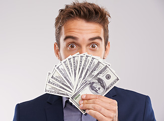 Image showing Face, man and money for investment in studio on white background with cash for business and funding. Portrait, happy and entrepreneur with paper notes or finance for startup company and growth