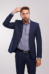 Image showing Confused, businessman and studio portrait thinking, puzzled employee with idea for question. Professional, wondering expression for corporate job, formal and scratching head on isolated background