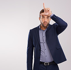 Image showing Portrait, employee or man with loser gesture, startup failure or facial expression on white studio background. Face, agent or consultant with emoji or L sign with social media or review with feedback