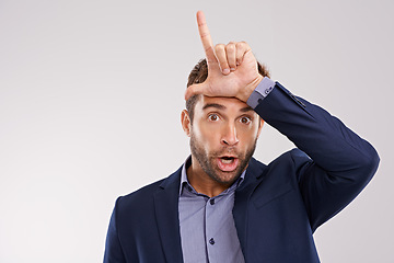 Image showing Portrait, business and man with loser gesture, fail and facial expression on a white studio background. Face, employee and entrepreneur with emoji and L sign with social media or review with feedback