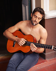 Image showing Guy, guitar or home to relax as inspiration, thinking or idea of future, smoking or vision on break. Man, shirtless or cigarette as musical instrument to remember, chill or rest at weekend getaway
