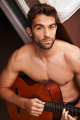 Image showing Portrait, home and guitar with man, topless and training with talent or sound with musician. Face, person or apartment with guy or string instrument for practice or confidence with hobby or shirtless