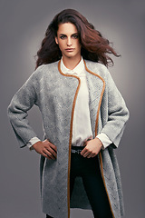 Image showing Woman, portrait and elegant fashion in studio with confidence, classy style and trendy aesthetic with coat. Model, person and face with attitude in stylish clothes and hairstyle on grey background
