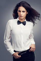 Image showing Woman, bow tie or portrait of fashion model with vintage clothes or classy aesthetic in studio. Confidence, edgy lady or person with retro style, elegance and cool hair isolated on grey background