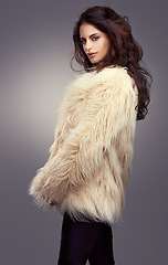 Image showing Fur coat, winter or woman in studio or portrait for cool style, trendy jacket or comfortable outfit. Chic, lady or model with satisfaction in cozy fashion wear or casual clothing on grey background