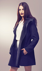 Image showing Coat, fashion model or woman in portrait or studio in cool style, trendy jacket or comfortable outfit. Chic lady, gothic or confident person in cozy wear or elegant winter clothing on grey background