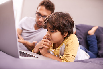 Image showing Thinking, father and child with computer for learning in bedroom with connectivity, technology at home. Family, man and young boy in bed with laptop for online studying and bonding together in house