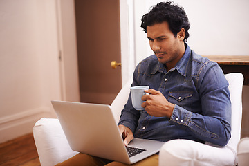 Image showing Coffee, laptop and man on sofa reading information online for freelance creative project at home. Technology, confused and designer drink cappuccino and work on computer in living room at apartment.