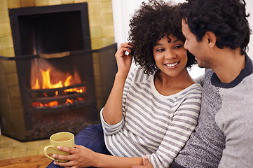 Image showing Couple, fireplace and relax for care and home for peace, smile and proud of marriage and commitment. Happy people, coffee and date on floor in lounge on weekend, support and trust in relationship