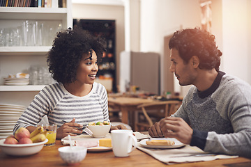 Image showing Breakfast, happy and couple in conversation in kitchen bonding together at apartment. Smile, love and man and woman talking and eating healthy food or meal in morning by dining table at modern home.