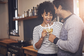 Image showing Couple, kitchen and wine for toast and love in home, smile and proud of marriage and commitment. Happy people, milestone and drinking alcohol on weekend, support and celebration for relationship