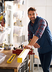 Image showing Carpenter, smile and portrait of man in home workshop for furniture, manufacturing and production. Male person, tools and handyman with equipment for renovation, maintenance or woodwork in garage