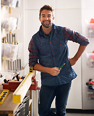 Image showing Portrait, wood and carpenter man with diy tools for home development, woodwork and building renovation. Smiling, male employee and contractor for maintenance, equipment and repair work in garage