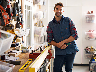 Image showing Carpenter, wood and portrait of man in workshop for home development, diy tools and building renovation. Smiling, male employee and contractor for maintenance, equipment and repair work in garage