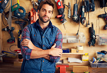 Image showing Man, portrait and tools with arms crossed for home development, construction and renovation in workshop. Carpenter, male employee and contractor for maintenance, drill and repair work for diy