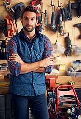 Image showing Carpenter, tools and portrait of man with arms crossed for home development, maintenance and renovation in workshop. Confident, male person and contractor for construction, equipment and repair work