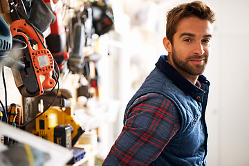 Image showing Tools, carpenter and portrait of man in garage for manufacturing, production or small business. Male person, equipment and handyman with smile for renovation, maintenance or remodeling in workshop