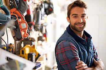 Image showing Smile, carpenter and portrait of man in garage for production, manufacturing or small business. Male person, tools and handyman with equipment for renovation, remodeling or maintenance in workshop