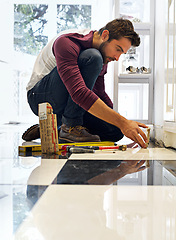 Image showing Tools, contractor and man on floor for maintenance, small business repairs or building development. Construction, worker and male person with equipment for renovation, installation and service