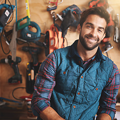 Image showing Tools, carpenter and portrait of man in workshop for home development, construction and renovation. Confidence, contractor and male employee for maintenance, repair work and smiling in garage