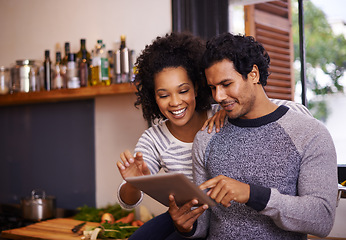 Image showing Couple, tablet and cooking in kitchen with smile for online recipe, nutrition information and digital instructions. Man, woman and touchscreen in home for food website, bonding or happy for meal prep