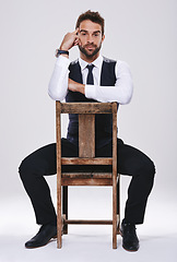 Image showing Chair, thinking and portrait of man with suit for fashion, style or formal wear isolated on white background. Male person, gentleman or businessman with trendy clothes, classy or outfit in studio