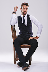 Image showing Chair, confidence and portrait of man with suit for fashion, style or formal wear isolated on white background. Male person, gentleman or businessman with trendy clothes, class or outfit in studio