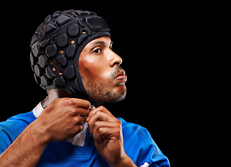 Image showing Rugby, dark studio background and man getting ready for training, competition and sportswear. Athlete, player and young male person with confidence for professional sport, workout or exercise